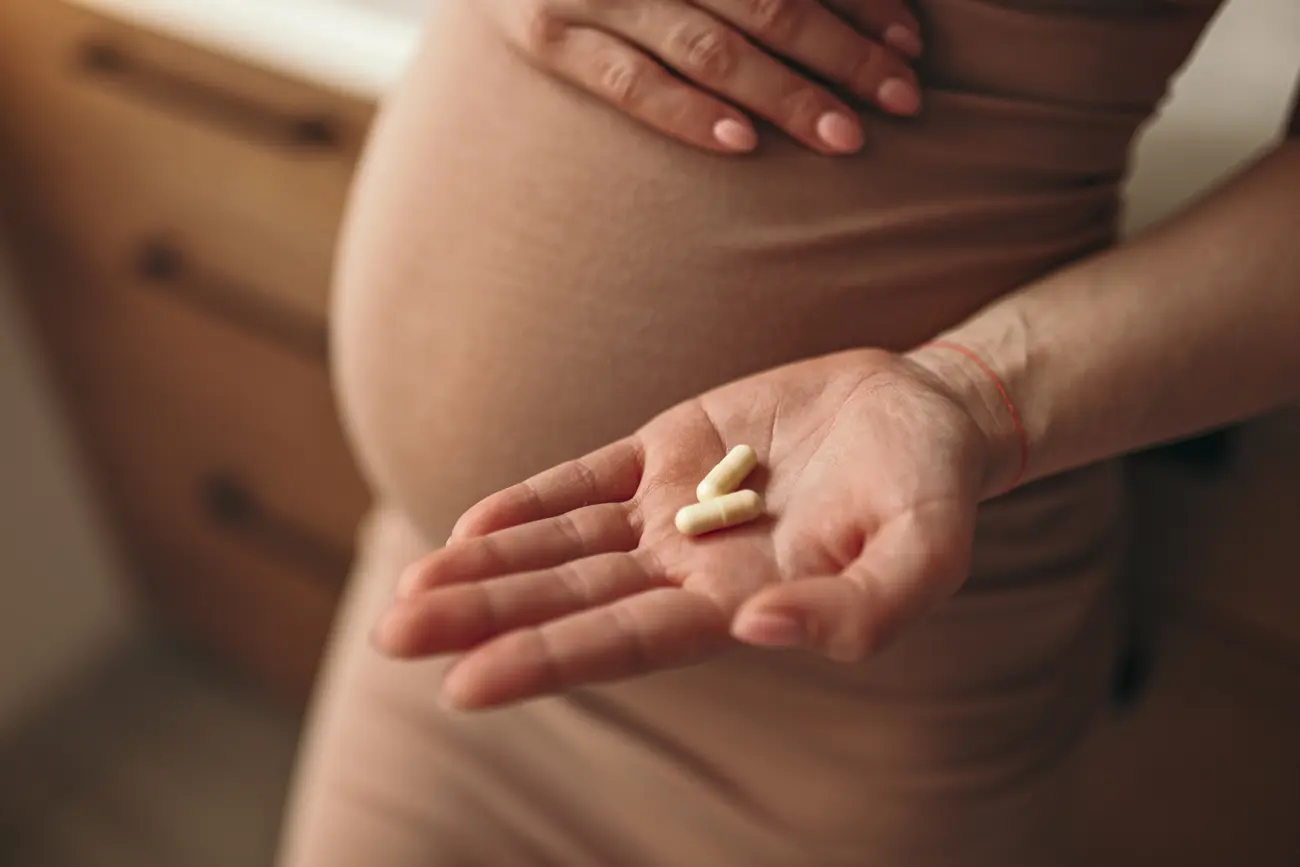 pregnant woman with pills in hand 2023 11 27 04 56 45 utc